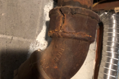 Cracked and corroded 74-year-old cast iron drain line.