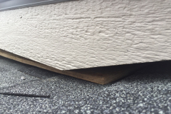 Another brand new house, this time with a soffit board laying loose on the roofing shingles, under the eave.